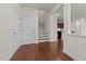 Bright foyer featuring hardwood floors, staircase, and a glimpse of the kitchen at 1700 Cary Reserve Dr, Cary, NC 27519