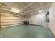 Spacious garage with painted walls, a roll-up door, and ample room for parking and storage at 1700 Cary Reserve Dr, Cary, NC 27519