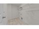 Bright laundry room with tile flooring, wire shelving, and hookups for a washer and dryer at 1700 Cary Reserve Dr, Cary, NC 27519
