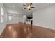 Open-concept living room with hardwood floors and neutral paint, leading into the kitchen area at 1700 Cary Reserve Dr, Cary, NC 27519