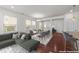 Staged open-concept living room featuring a dining area, modern furnishings, and lots of natural light at 1700 Cary Reserve Dr, Cary, NC 27519