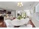 Open-concept living space featuring updated lighting, a modern kitchen, and hardwood floors at 1700 Cary Reserve Dr, Cary, NC 27519