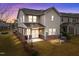 Two-story home with vinyl siding, rear patio, and manicured lawn during twilight at 1700 Cary Reserve Dr, Cary, NC 27519