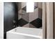 Modern bathroom with geometric tile, a white bathtub, and shower at 202 Dundas Ln, Raleigh, NC 27603