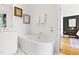 Modern bathroom with freestanding tub, marble floors, and ample counter space at 202 Dundas Ln, Raleigh, NC 27603