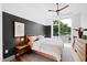 Main bedroom with large windows, a comfortable bed, and modern wood dresser at 202 Dundas Ln, Raleigh, NC 27603