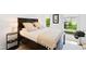 Bedroom with dark wood bed frame and neutral bedding at 202 Dundas Ln, Raleigh, NC 27603
