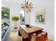 Light-filled dining area with wood table, bench seating, and modern chandelier at 202 Dundas Ln, Raleigh, NC 27603