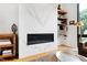 Modern living room with marble fireplace, floating shelves, and large window at 202 Dundas Ln, Raleigh, NC 27603