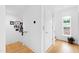 Bright hallway with hardwood floors, modern light fixtures, and photo gallery wall at 202 Dundas Ln, Raleigh, NC 27603