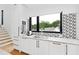 Modern kitchen with white cabinets and geometric backsplash at 202 Dundas Ln, Raleigh, NC 27603