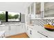 White kitchen with marble countertops and glass-front cabinets at 202 Dundas Ln, Raleigh, NC 27603