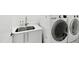 Modern laundry room with white cabinets and stainless steel sink at 202 Dundas Ln, Raleigh, NC 27603