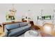 Open living room and kitchen with hardwood floors, modern furniture, and large windows at 202 Dundas Ln, Raleigh, NC 27603