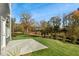 Small patio and backyard with green grass and wooded area at 2330 Sugar Cone Way, Fuquay Varina, NC 27526