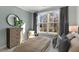Cozy bedroom with large window, plush bedding, and a view of the backyard at 2330 Sugar Cone Way, Fuquay Varina, NC 27526