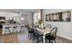 Open dining area with farmhouse table and chairs, near kitchen and living room at 2330 Sugar Cone Way, Fuquay Varina, NC 27526