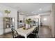 Farmhouse style dining room with white table and black chairs, adjacent to kitchen at 2330 Sugar Cone Way, Fuquay Varina, NC 27526