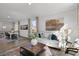 Bright living room features hardwood floors, comfy seating, and a view into the dining area at 2330 Sugar Cone Way, Fuquay Varina, NC 27526
