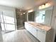 Bright bathroom featuring double sinks, modern fixtures, and a glass-enclosed shower at 25 Accord Dr, Youngsville, NC 27596