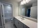 This is a clean and modern bathroom with ample counter space and a shower-tub combo at 25 Accord Dr, Youngsville, NC 27596