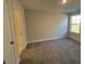 This cozy bedroom features soft carpet, neutral colors, and a view of the outdoors at 25 Accord Dr, Youngsville, NC 27596