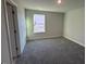 This comfortable bedroom features soft carpet, neutral colors, and a view of the outdoors at 25 Accord Dr, Youngsville, NC 27596