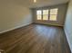 This cozy bedroom features wood flooring and plenty of natural light at 25 Accord Dr, Youngsville, NC 27596
