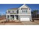 Charming two-story home featuring a two-car garage and classic gray siding at 25 Accord Dr, Youngsville, NC 27596