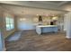 Open concept living room and kitchen with hardwood floors and stainless appliances at 25 Accord Dr, Youngsville, NC 27596