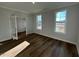 Bright, empty living room with dark hardwood floors and plenty of natural light at 25 Accord Dr, Youngsville, NC 27596