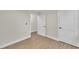 Light bedroom with wood-look floors and two doors at 2538 Gemena Rd, Chapel Hill, NC 27516