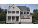 Two-story home with gray brick exterior, white trim, and a two-car garage at 2618 Marchmont St, Raleigh, NC 27608