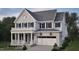 Two-story home with gray brick exterior, white trim, and a two-car garage at 2618 Marchmont St, Raleigh, NC 27608