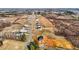 Expansive aerial view of a new construction neighborhood with homes lined up along a long street and surrounded by open fields at 2995 Faucette Ln, Burlington, NC 27217