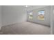 Spacious bedroom with neutral carpet, two windows bringing in lots of natural light at 2995 Faucette Ln, Burlington, NC 27217