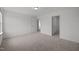 Bedroom featuring neutral carpet, a single window, and multiple doorways at 2995 Faucette Ln, Burlington, NC 27217
