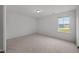 Clean bedroom with neutral carpet and a single window at 2995 Faucette Ln, Burlington, NC 27217