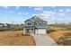 New construction two-story home with blue siding and an orange front door at 2995 Faucette Ln, Burlington, NC 27217