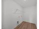 Laundry room with wire shelving, wood-look floor, and washer-dryer hookups at 2995 Faucette Ln, Burlington, NC 27217