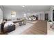 Bright and airy living space with modern furniture, wood floors, and an open-concept kitchen at 2995 Faucette Ln, Burlington, NC 27217