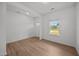Living room with wood-look floors, white walls, and a bright window at 2995 Faucette Ln, Burlington, NC 27217
