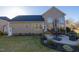 Landscaped backyard with stone patio and dining set offering an ideal space for relaxation and outdoor dining at 30155 Pharr, Chapel Hill, NC 27517