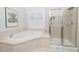 This bathroom features a soaking tub, shower with glass door, and white wood shutters at 30155 Pharr, Chapel Hill, NC 27517