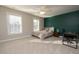 This bedroom has a stylish accent wall, carpet floor, and a ceiling fan at 30155 Pharr, Chapel Hill, NC 27517