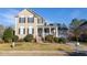 Charming two-story home with manicured lawn, inviting front porch, and traditional architectural details at 30155 Pharr, Chapel Hill, NC 27517