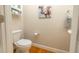 Tastefully decorated half bathroom with hardwood floors, toilet, and storage cabinet at 30155 Pharr, Chapel Hill, NC 27517