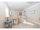 The hallway boasts neutral walls, modern lighting, and wood banisters at 30155 Pharr, Chapel Hill, NC 27517