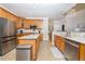 Open kitchen with granite counters, stainless steel appliances, and a large island at 30155 Pharr, Chapel Hill, NC 27517