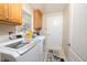Bright laundry room featuring updated washer and dryer, storage cabinets, and exterior access at 30155 Pharr, Chapel Hill, NC 27517